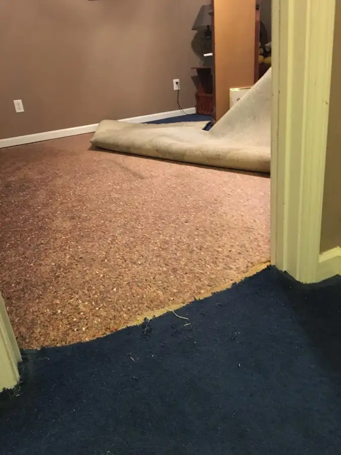 Carpet pad removal revealing water damage during Drying & Dehumidification in Broken Arrow